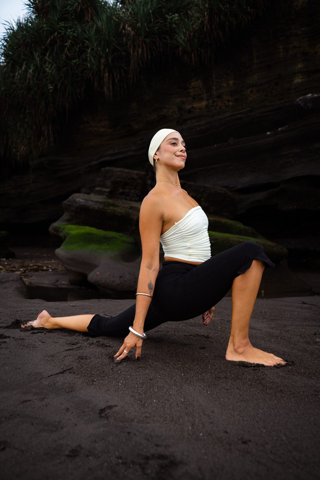 Irene del Valle practicing yoga on a black sand beach